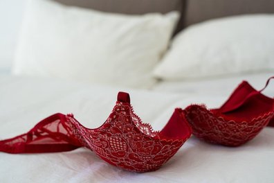 Red Bra on a bed.