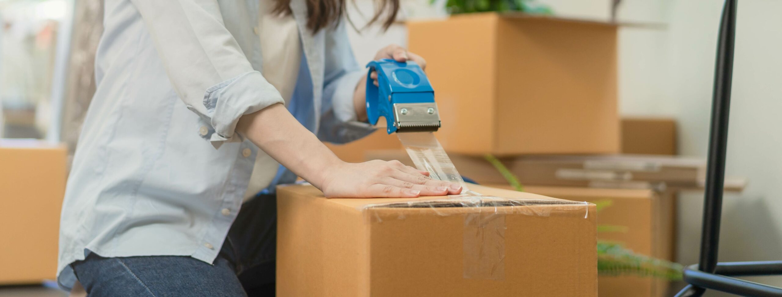 a person sealing a box