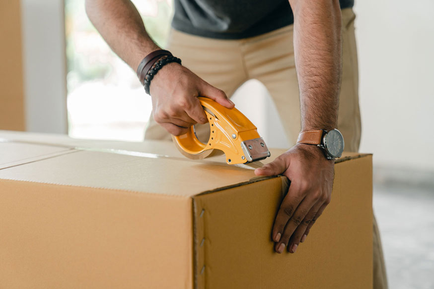 a man sealing a box