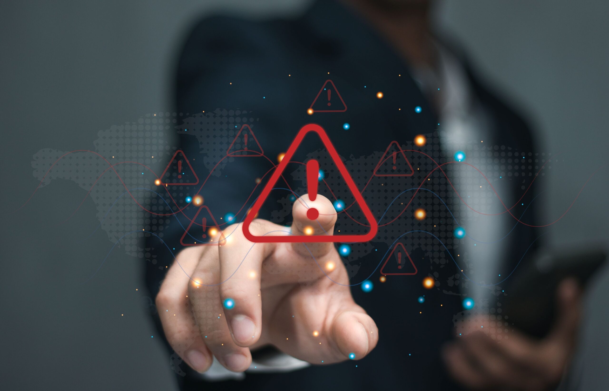 A person holding a smartphone taps a red warning icon (an exclamation mark inside a triangle).