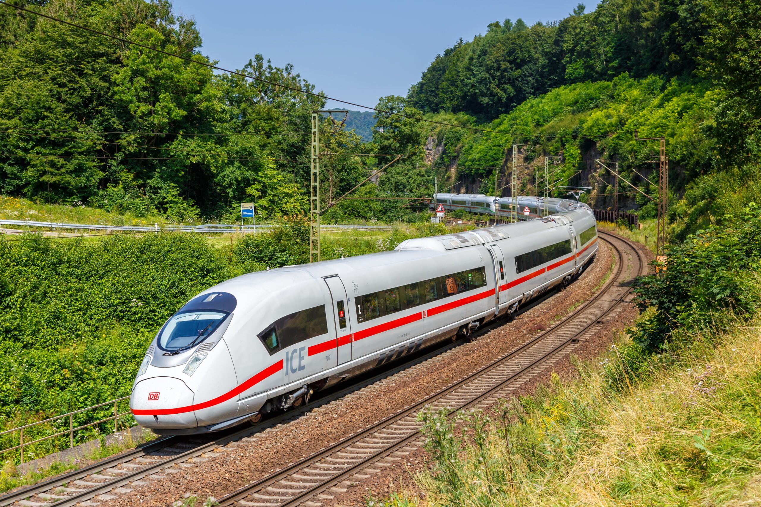 ICE high-speed train travels through green countryside