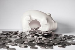 A white piggy bank with coins.