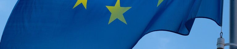 Flag of Europe. It consists of a circle of twelve five-pointed golden stars on a blue field.